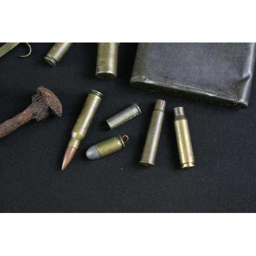 459 - A group of mixed military collectables to include a Kukri knife, inert artillery shell, inert bullet... 