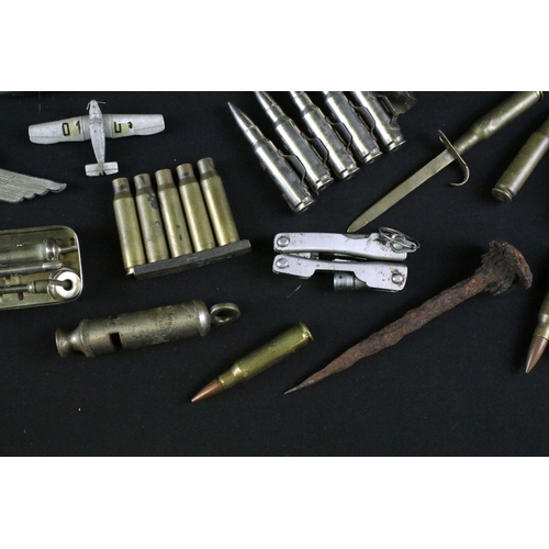 459 - A group of mixed military collectables to include a Kukri knife, inert artillery shell, inert bullet... 