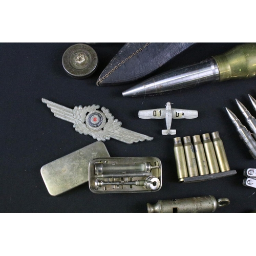 459 - A group of mixed military collectables to include a Kukri knife, inert artillery shell, inert bullet... 