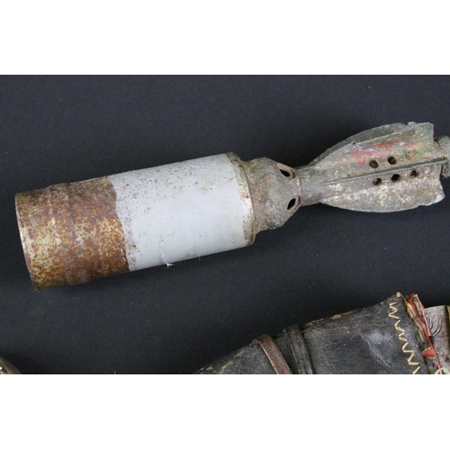 459 - A group of mixed military collectables to include a Kukri knife, inert artillery shell, inert bullet... 