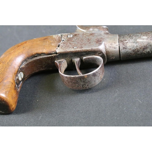 479 - A 19th Century Percussion Pistol. The mechanism engraved with scrolled floral decoration. The trigge... 