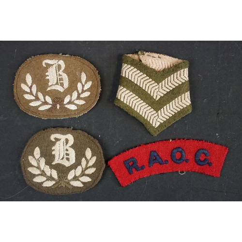 513 - A small collection of British military issued cloth badges to include Royal Army ordnance Corps toge... 