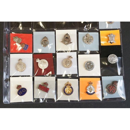 516 - A large collection of military badges to include cap badges, collar badges, military association bad... 