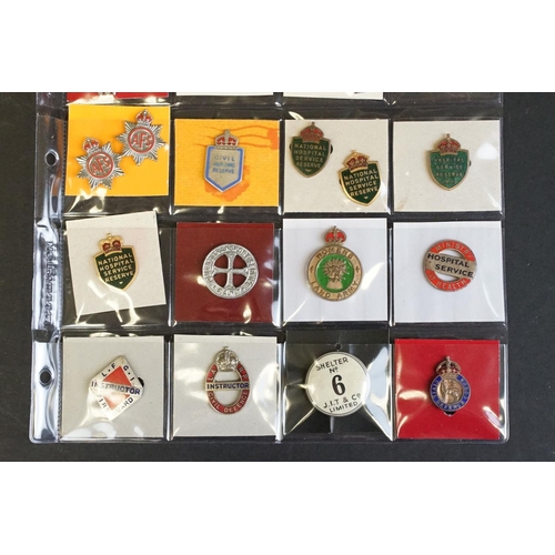 516 - A large collection of military badges to include cap badges, collar badges, military association bad... 