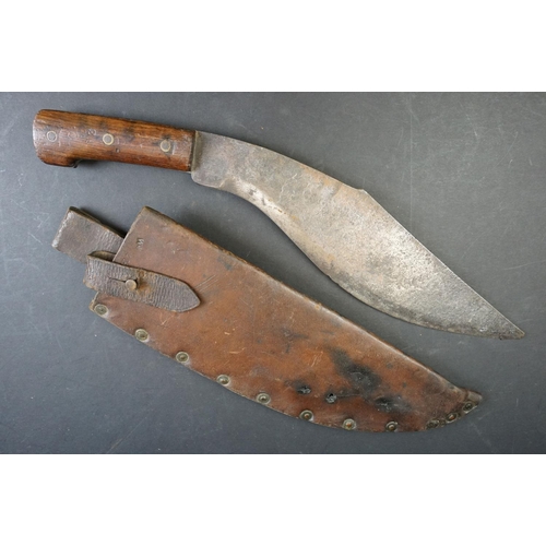 54 - A World War One / WW1 1917 Dated Military Issue Kukri knife, two piece wooden grips with three brass... 