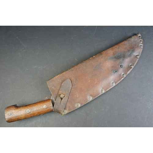 54 - A World War One / WW1 1917 Dated Military Issue Kukri knife, two piece wooden grips with three brass... 