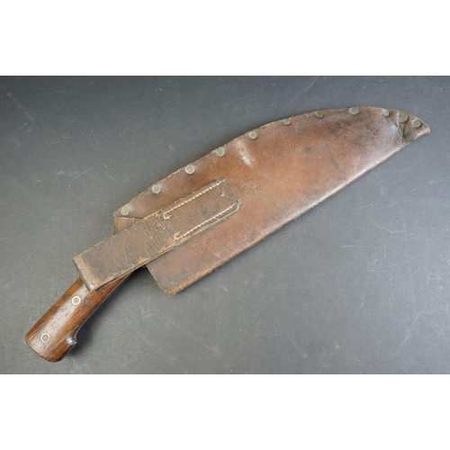 54 - A World War One / WW1 1917 Dated Military Issue Kukri knife, two piece wooden grips with three brass... 