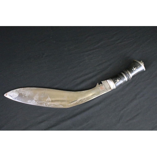 79 - A vintage Kukri knife, Inlayed horn handle, white metal fixings, lion head pommel, dot engraved stee... 