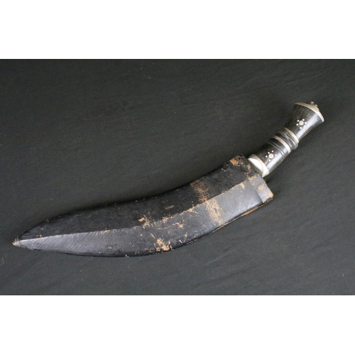 79 - A vintage Kukri knife, Inlayed horn handle, white metal fixings, lion head pommel, dot engraved stee... 