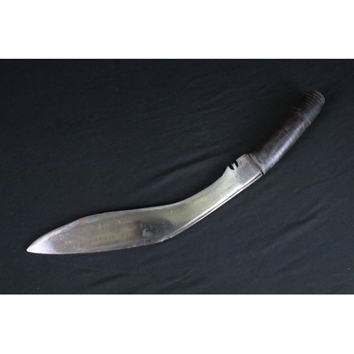 83 - A mid 20th century Kukri knife, modified stacked leather handle, blade measures approx 30cm, handle ... 