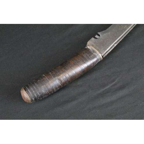 83 - A mid 20th century Kukri knife, modified stacked leather handle, blade measures approx 30cm, handle ... 