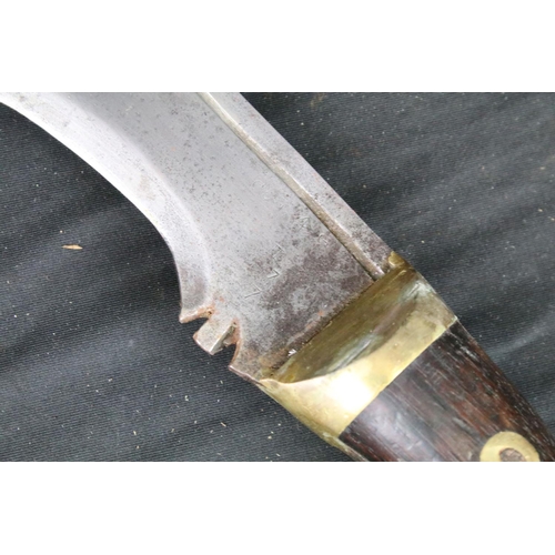 86 - A World War Two era large Kukri knife, steel blade, wooden handle with brass fixings, broad arrow ma... 