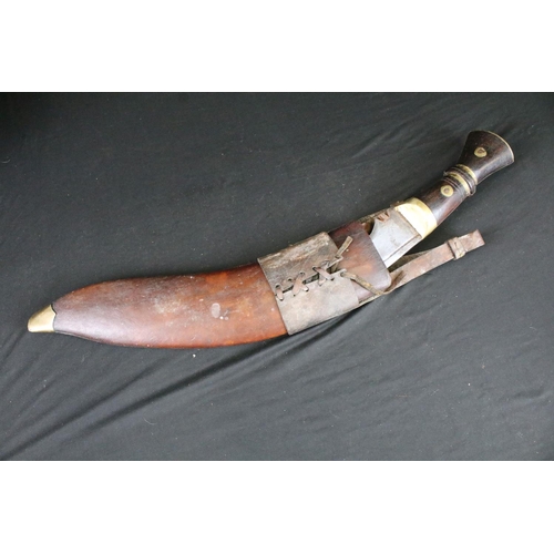 86 - A World War Two era large Kukri knife, steel blade, wooden handle with brass fixings, broad arrow ma... 