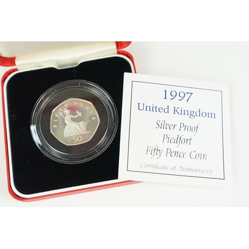 107 - A collection of four Royal Mint Queen Elizabeth II 50p silver proof coins to include 1997, 1993, 200... 