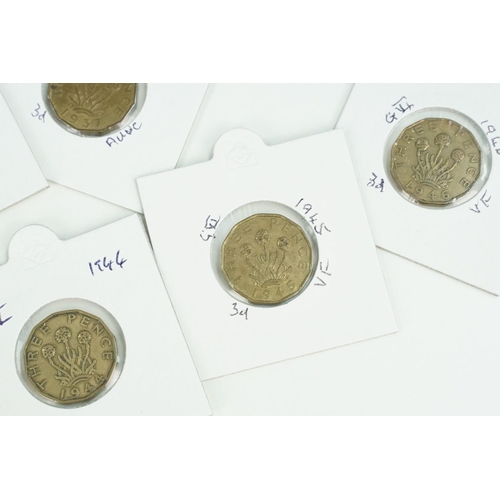 121 - A large collection of Royal Mint United Kingdom brass threepence coins within coin sleeves and toget... 