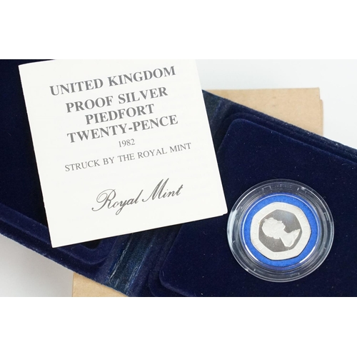 123 - A collection of Royal Mint United Kingdom silver proof coins to include £5, 5p, 10p and 20p examples... 