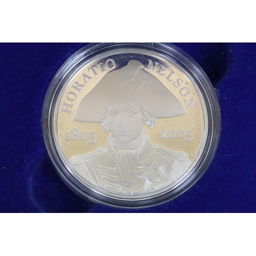 129 - A collection of four Royal Mint Queen Elizabeth II £5 silver proof coins to include 2005, 2016, 2002... 