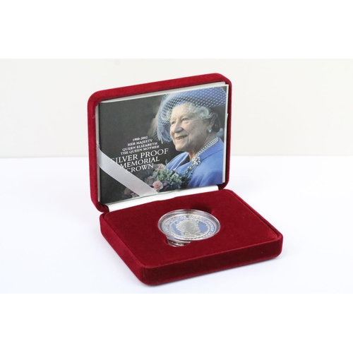 129 - A collection of four Royal Mint Queen Elizabeth II £5 silver proof coins to include 2005, 2016, 2002... 