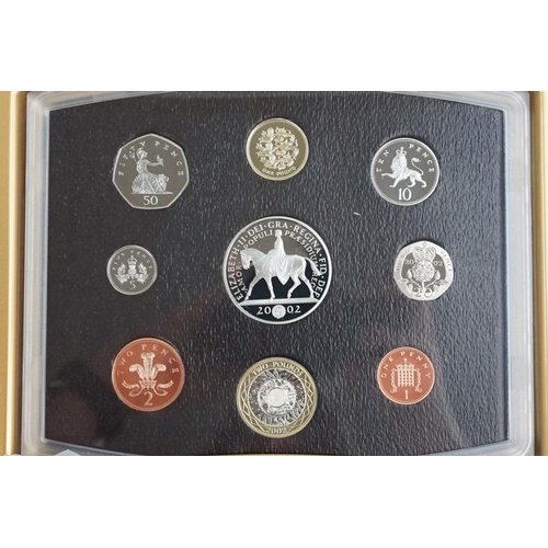 202 - A collection of four Royal Mint United Kingdom Queen Elizabeth II annual proof coin sets to include ... 