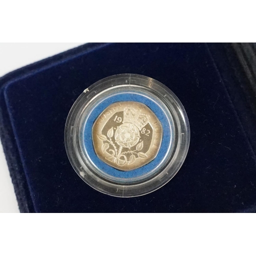 28 - A collection of four Royal Mint silver proof coins to include the 1982 20p coin, 1988 £1 coin, 1997 ... 