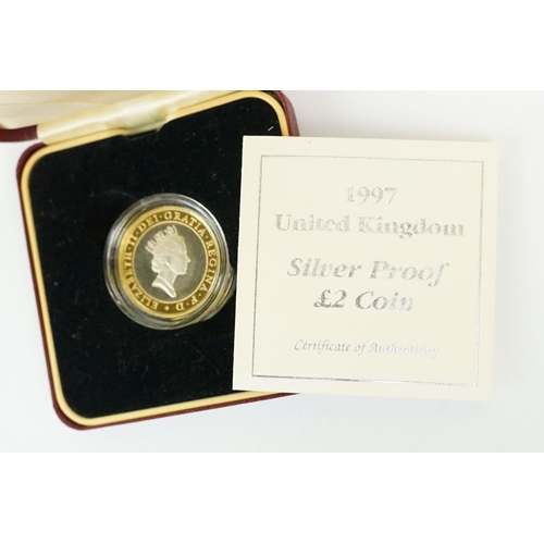 28 - A collection of four Royal Mint silver proof coins to include the 1982 20p coin, 1988 £1 coin, 1997 ... 