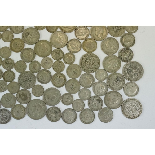 74 - A large collection of British pre decimal silver coins to include half crowns, florins, shillings an... 