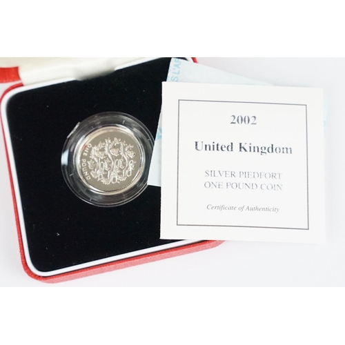 89 - A collection of four Royal Mint Queen Elizabeth II £1 silver proof coins to include 2002, 2000, 2003... 