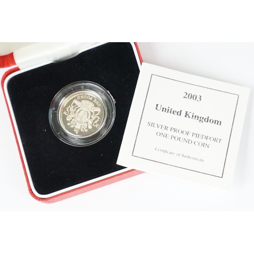 89 - A collection of four Royal Mint Queen Elizabeth II £1 silver proof coins to include 2002, 2000, 2003... 