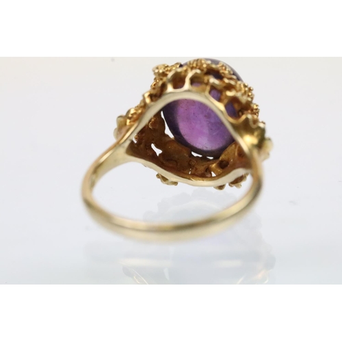43 - Vintage 9ct gold and amethyst ring. The ring being set with an oval amethyst cabochon set within pie... 