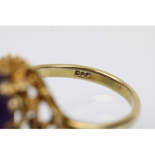 43 - Vintage 9ct gold and amethyst ring. The ring being set with an oval amethyst cabochon set within pie... 