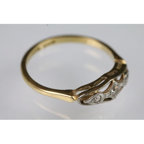 54 - Art Deco 18ct gold and diamond ring having a pierced panel head set with three round cut diamonds. M... 