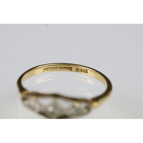 54 - Art Deco 18ct gold and diamond ring having a pierced panel head set with three round cut diamonds. M... 
