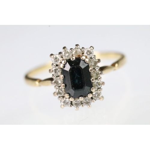 56 - 18ct gold sapphire and diamond ring. The ring being set with a rectangular step cut sapphire to cent... 