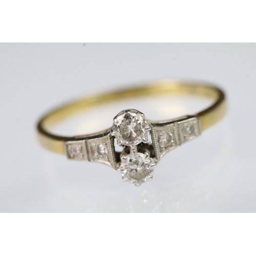 58 - Art Deco 18ct gold and diamond ring. The ring set with two round brilliant cut diamonds to the head ... 