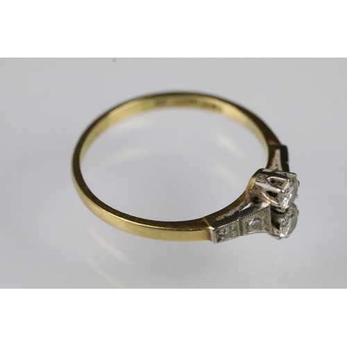 58 - Art Deco 18ct gold and diamond ring. The ring set with two round brilliant cut diamonds to the head ... 