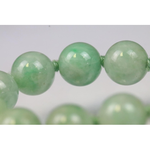 17 - Jace beaded necklace threaded with green jadeite spherical beads with a 9ct gold clasp. Measures 15 ... 