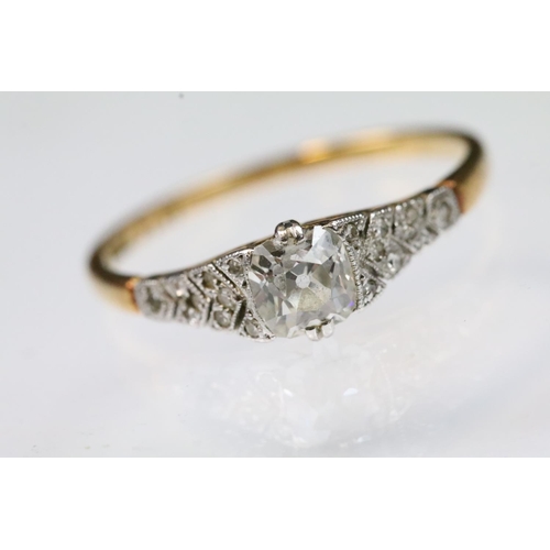 29 - Art Deco 18ct gold and platinum diamond ring. The ring being set with a cushion cut diamond to the h... 