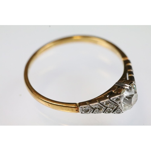 29 - Art Deco 18ct gold and platinum diamond ring. The ring being set with a cushion cut diamond to the h... 