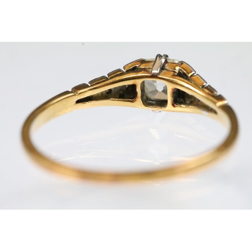 29 - Art Deco 18ct gold and platinum diamond ring. The ring being set with a cushion cut diamond to the h... 