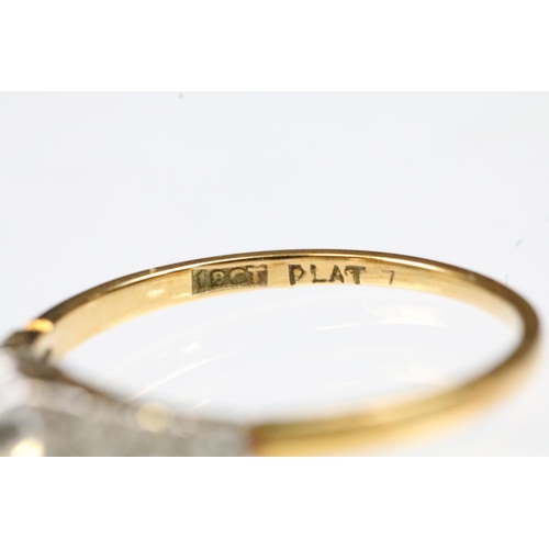 29 - Art Deco 18ct gold and platinum diamond ring. The ring being set with a cushion cut diamond to the h... 
