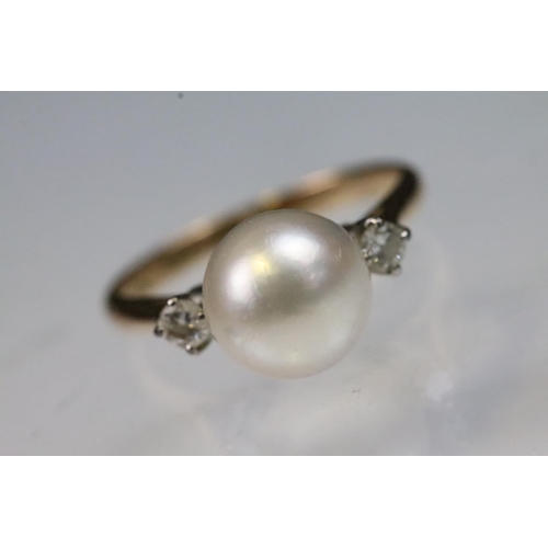36 - 14ct gold, pearl and diamond ring. The ring being set with a central cultured pearl flanked by two r... 