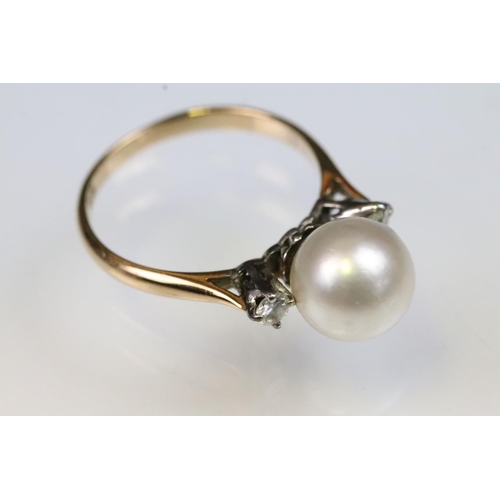 36 - 14ct gold, pearl and diamond ring. The ring being set with a central cultured pearl flanked by two r... 