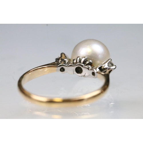 36 - 14ct gold, pearl and diamond ring. The ring being set with a central cultured pearl flanked by two r... 