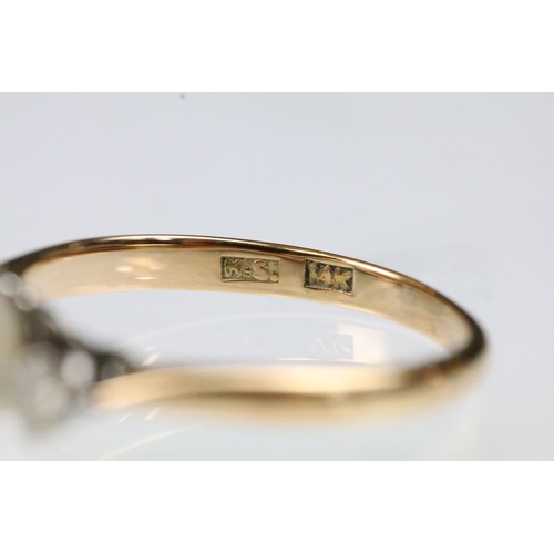 36 - 14ct gold, pearl and diamond ring. The ring being set with a central cultured pearl flanked by two r... 