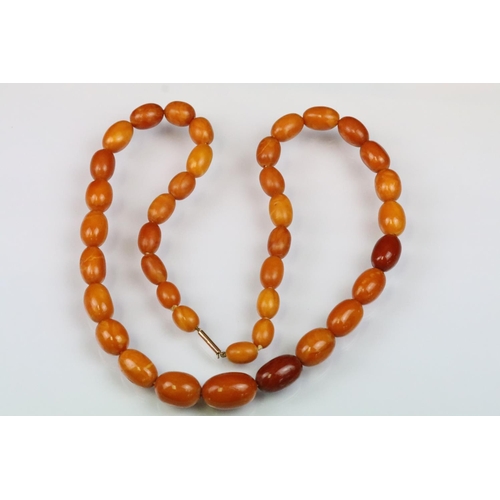 6 - Butterscotch amber beaded necklace having 39 graduating oval beads with a 9ct gold clasp. Largest be... 