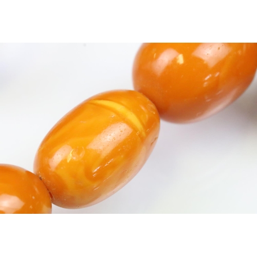 6 - Butterscotch amber beaded necklace having 39 graduating oval beads with a 9ct gold clasp. Largest be... 