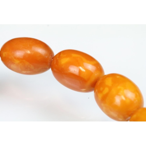 6 - Butterscotch amber beaded necklace having 39 graduating oval beads with a 9ct gold clasp. Largest be... 