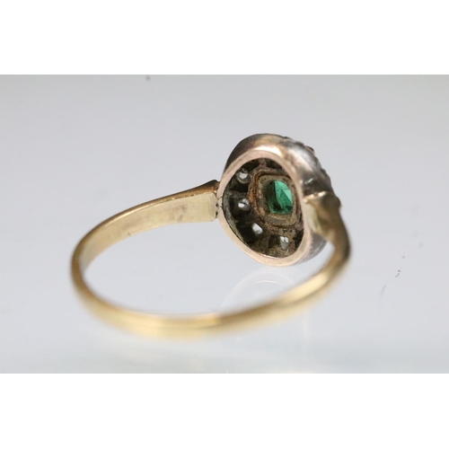 31 - 19th Century Victorian emerald and diamond halo ring. The ring being set with a step cut emerald to ... 