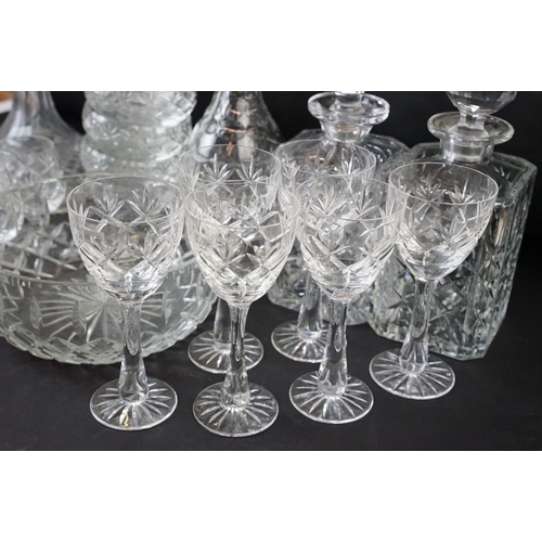 72 - Large selection of cut glass with decanters including two square cut, one round and a ship decanter ... 