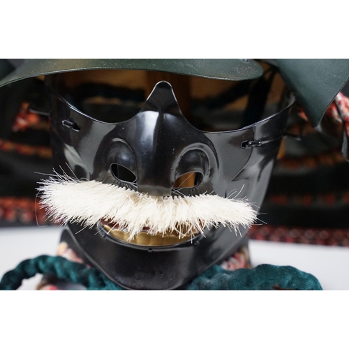 100 - Japanese Samurai helmet suit of armour replica with colourful cotton thread weaving on mount stand.